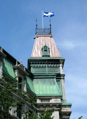 Close-up of a tower and a copper rooftop.