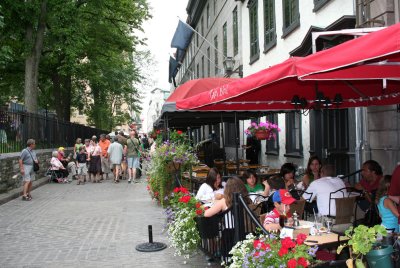 Nice street with outdoor cafes and flowers.