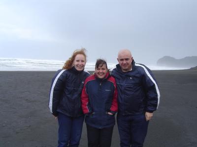 Leonie, me and Uncle Paul getting sand blasted at Piha.JPG