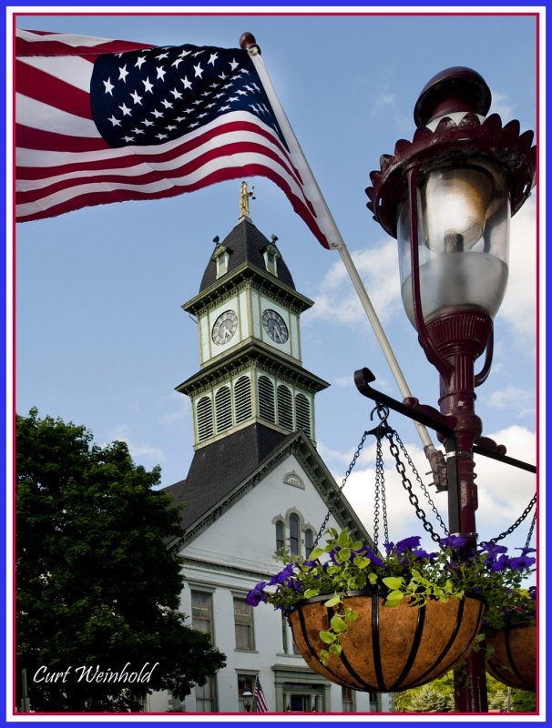 Lamp post flag and flower baskets