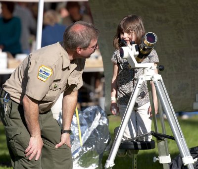 DCNR specialist helping a child view sunspots.