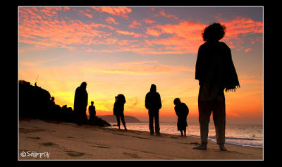 Participants of trance party watching the sunrise in Half-Moon beach, Karnataka.