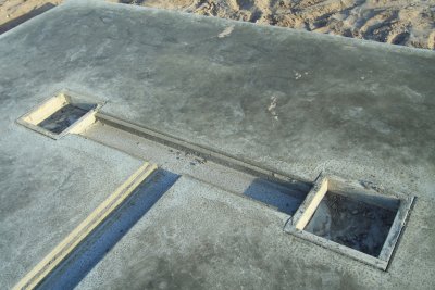 slab with chase for electric and two 16 X 16 cut outs for separate concrete piers 