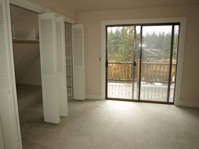 Bedroom with slide to deck overlooking river