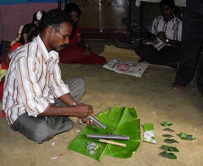 Kani shamanism. Before the ceremony grains of rice are poured down the kokkara. Tirunelveli District, Tamil Nadu.