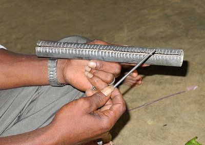 During the ceremony the shaman uses an iron nail to make music on the kokkara. Tirunelveli District, Tamil Nadu.