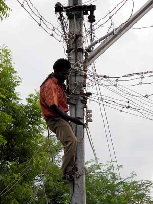 Repair of power cables in Tamil Nadu, India.