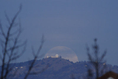 The Wolf Moon rising behind Lick Observatory