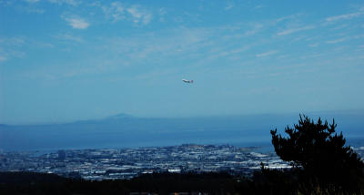Plane taking off from SFO with Mt DIablo rising above the fog