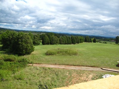 See the tiny little maple in front of the long line of tall firs? That's the far eastern boundary of our property.