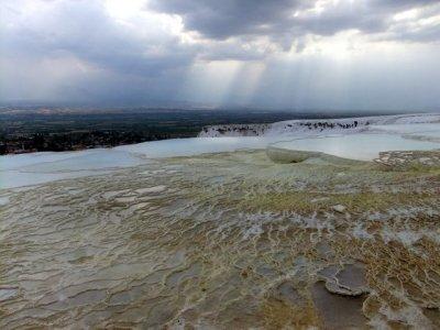 Pammukale with storm brewing. Calcium deposited by streams, looks like snow