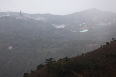 The giant Tian Tan Buddha of Ngong Ping, barely visible in the fog.