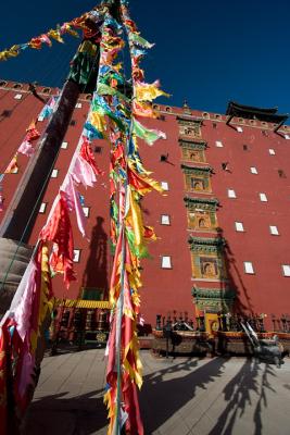 Prayer flag towers in front of the main palace, or Red Palace.