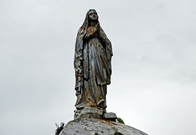 Statue of Our Lady of Lourdes on top of the church