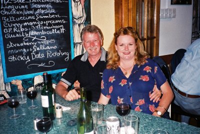 Jan and Tony sitting in front of the specials board