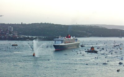 QM2 surrounded by boats