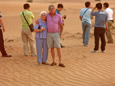 Marge and Dave in the desert in Dubai at dusk
