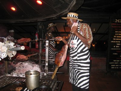 One of the waiters inspecting the meat