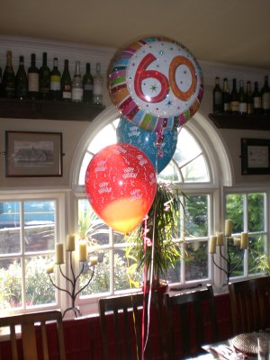 60th foil 2 latex happy birthday dining room window.JPG
