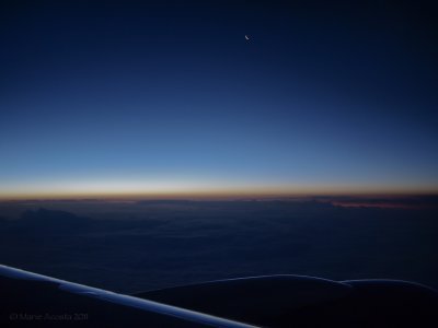 On our way back to Detroit...a sliver of moon hanging over the plane wing