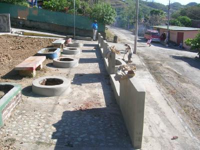 A wall and planters in need of trees and plants