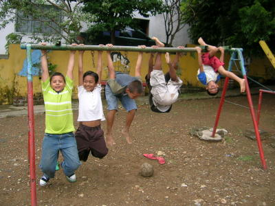 boys playing on the old swing set with no swings