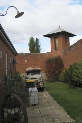 ONE OF THE WATCH TOWERS  AND AN OLD PRISON VAN