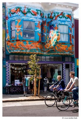 Cyclists on 24th St & dog in window.jpg