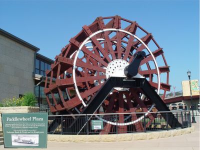 JUST ONE OF THE PADDLE WHEELS OFF OF THE STEAMBOAT
