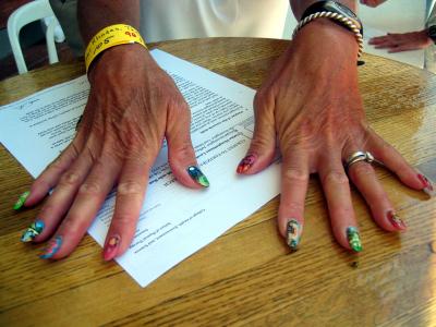Terri Rhodes paints one nail for each WS aid station