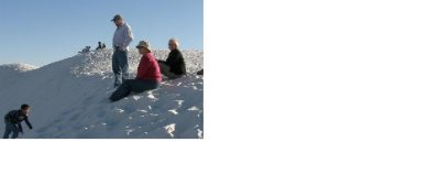 Sledding on the White Sands dunes.JPG