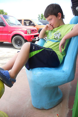 David in one of the hand chairs at the ice cream parlor