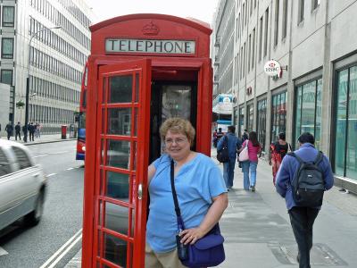 Ann at one of London's Red phone booths