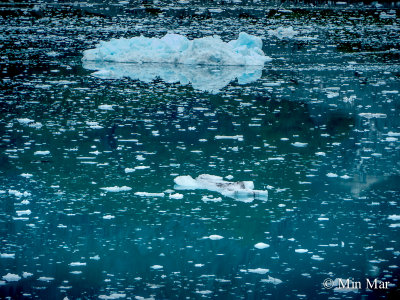 Floating chunks of ice - small and large silently stationed in the colorful cold water. Due to reflections of the glacier, the color appears greenish and bluish. PEACEFUL FEELINGS