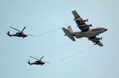 C-130 refuelling two HH-60G Pave Hawks