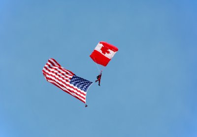 Canadian parachutist carrying US flag