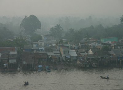 Shanty town sunrise, Chau Doc, Mekong Delta, Vietnam / Cambodia border. Taken from the balcony of a 5 star hotel. Messed up.