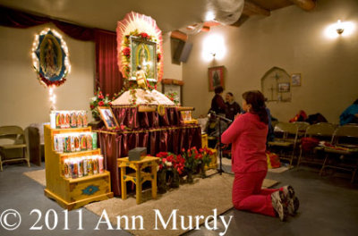 Lady praying to Our Lady of Guadalupe