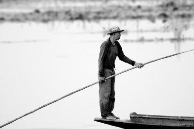 man on boat in black and white