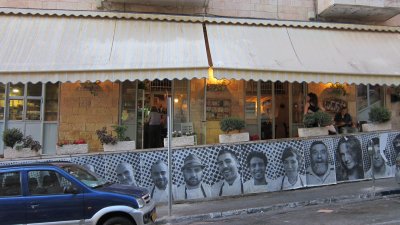 Machneyuda restuarant for dinner-outside is covered with portraits