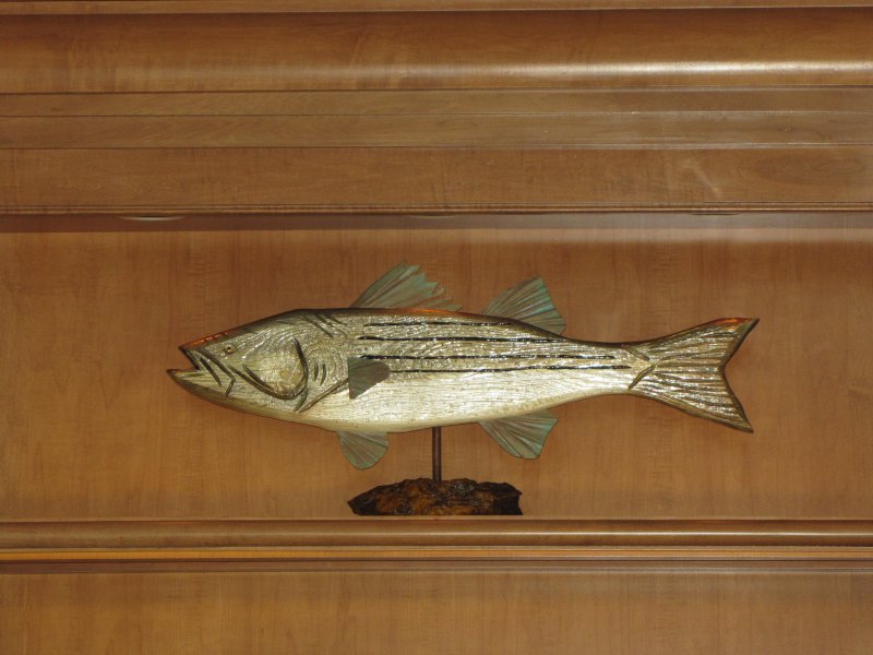 Rockfish (striped bass) on iron stone stand