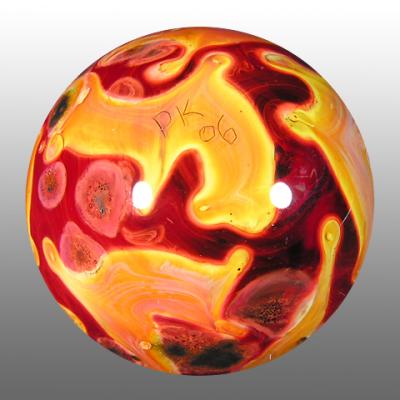 An intersting marble with an imploded A in the colorful vortex, and then chunks of shiny metal embedded in the backside.