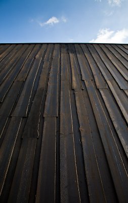 The tarred wooden walls of the new art museum Artipelag