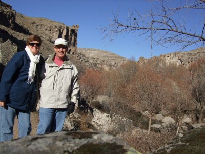 Carol and Bob in Ihlara Valley. The valley has a river surronded by sloping hillsides and then sheer cliffs.