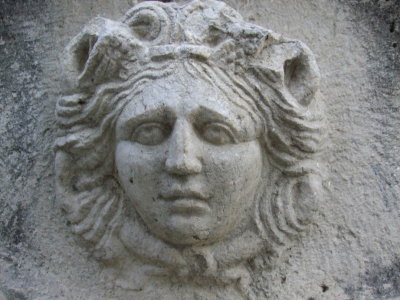 A lady's face at one end of the sarcophagus