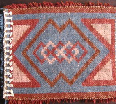 reverse of bag front flap, showing warp finish