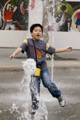 Boy running in the fountains