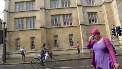 Biker, pedestrians and building Cambridge