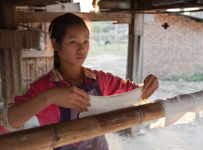 La folding the  rice noodles for storage