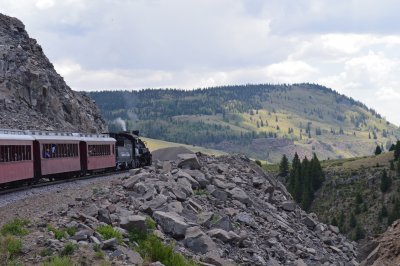 44 487 brings the train around a rock shelf as the clouds gather